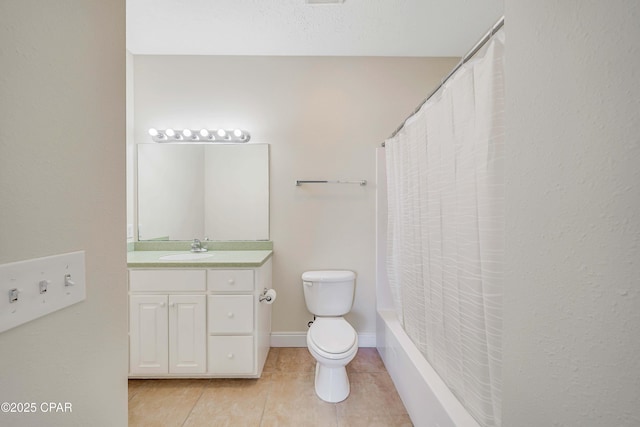 full bath with tile patterned floors, toilet, vanity, shower / bath combo with shower curtain, and baseboards
