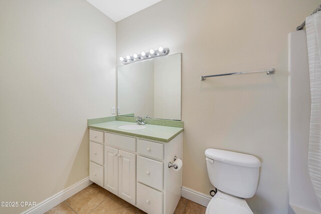 full bathroom featuring baseboards, tile patterned flooring, vanity, and toilet