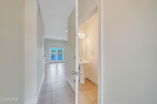 corridor featuring recessed lighting, visible vents, light tile patterned floors, french doors, and baseboards