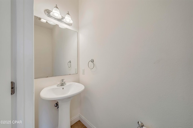 bathroom with baseboards and a sink