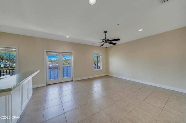 spare room featuring recessed lighting, a ceiling fan, french doors, light tile patterned floors, and baseboards