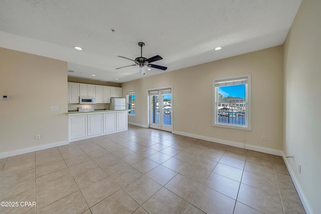 unfurnished living room featuring recessed lighting, baseboards, ceiling fan, and light tile patterned floors