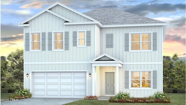 view of front of house featuring board and batten siding, a shingled roof, an attached garage, and driveway