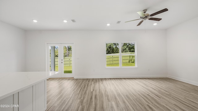 unfurnished room with light wood-style floors, recessed lighting, and visible vents