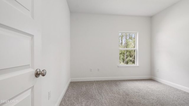 unfurnished room with carpet floors and baseboards