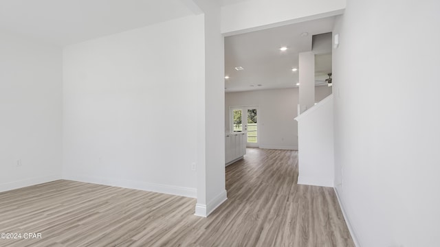 hall with recessed lighting, baseboards, and light wood finished floors