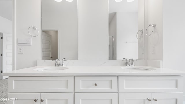 bathroom featuring a sink and double vanity