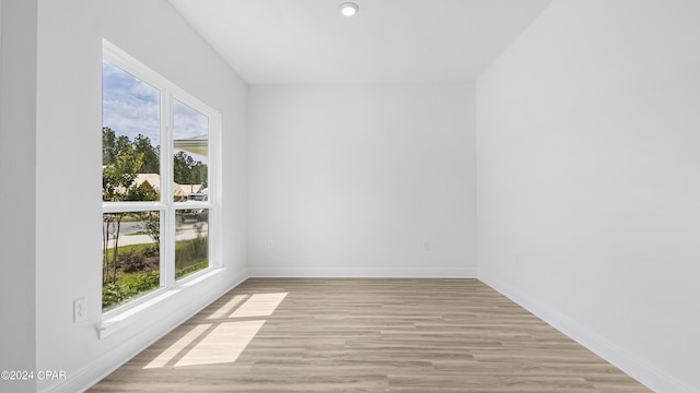 spare room with recessed lighting, baseboards, and light wood finished floors