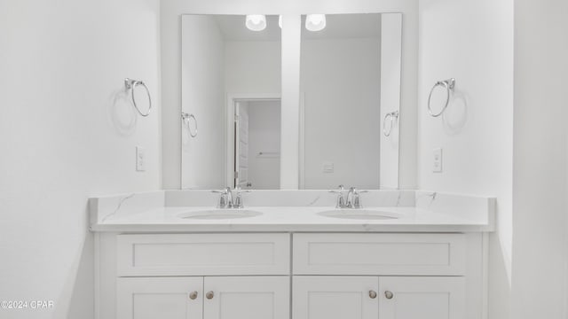 full bath with a sink and double vanity