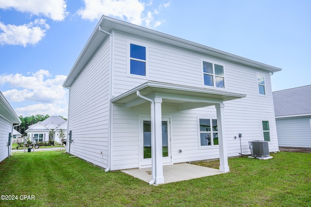 back of house with a patio, a yard, and central AC