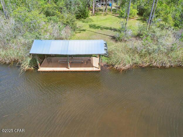 4435 Mill Bayou Rd, Panama City, FL 32404 - dock with a water view and a yard