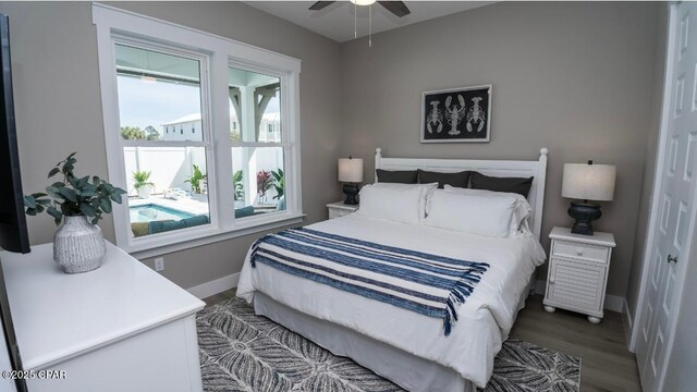 244 Sands St, Panama City Beach, FL 32413 - bedroom featuring baseboards, wood finished floors, and ceiling fan