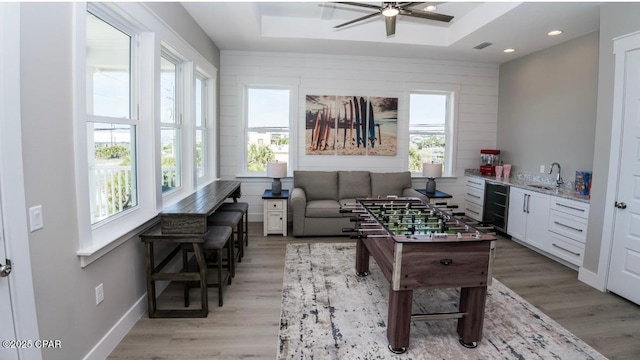 244 Sands St, Panama City Beach, FL 32413 - game room with a sink, healthy amount of natural light, a tray ceiling, light wood finished floors, and recessed lighting