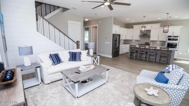 244 Sands St, Panama City Beach, FL 32413 - living area featuring ceiling fan, stairs, light wood-style flooring, recessed lighting, and baseboards