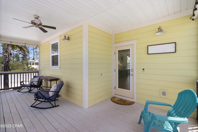 wooden deck featuring a ceiling fan