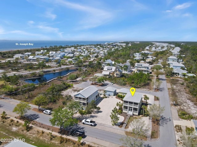birds eye view of property with a water view and a residential view