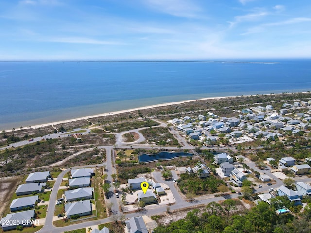 birds eye view of property with a water view, a residential view, and a view of the beach