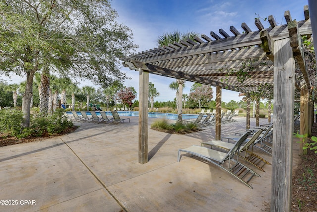 view of patio with a community pool and a pergola