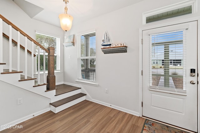 entryway featuring stairway, light wood-style flooring, and baseboards