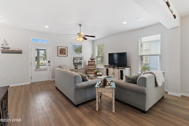living room featuring wood finished floors, a ceiling fan, visible vents, and recessed lighting