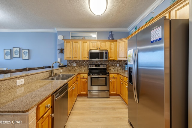 17643 Front Beach Rd Unit 1805, Panama City Beach, FL 32413 - kitchen featuring appliances with stainless steel finishes, a sink, ornamental molding, light wood finished floors, and a textured ceiling