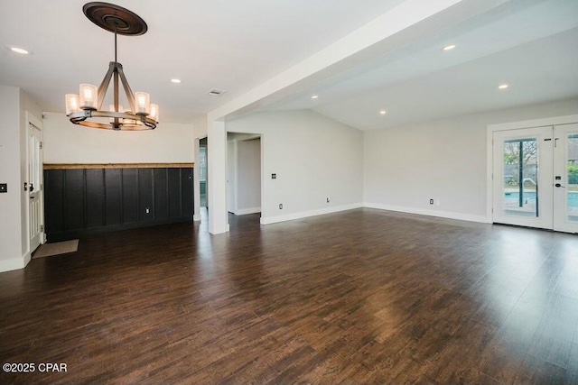 unfurnished living room with vaulted ceiling, a notable chandelier, baseboards, recessed lighting, and dark wood-style flooring