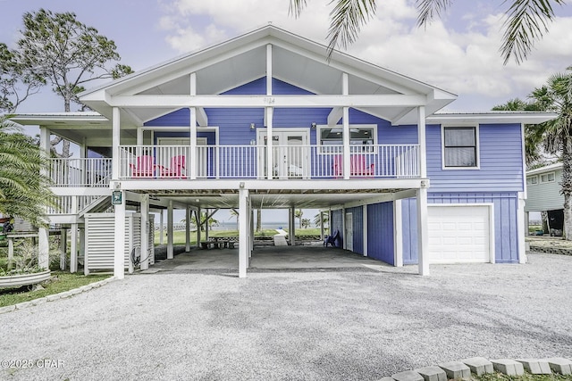 7124 Leeward St, Port St Joe, FL 32456 - coastal inspired home with driveway, a carport, covered porch, and stairs