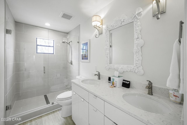 7124 Leeward St, Port St Joe, FL 32456 - bathroom featuring toilet, a stall shower, and double vanity
