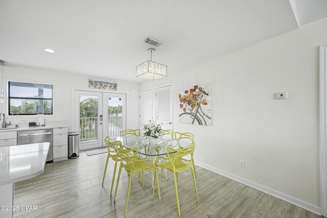 7124 Leeward St, Port St Joe, FL 32456 - dining room with a chandelier, light wood finished floors, french doors, baseboards, and recessed lighting