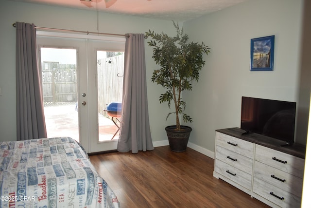 bedroom with dark wood finished floors, baseboards, access to outside, and multiple windows