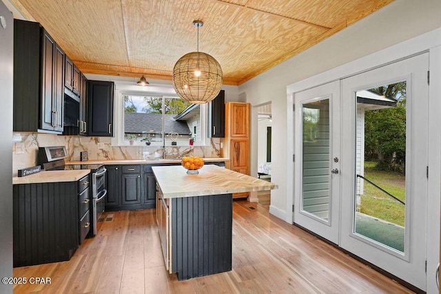 kitchen featuring range with two ovens, wood ceiling, tasteful backsplash, and light wood-type flooring