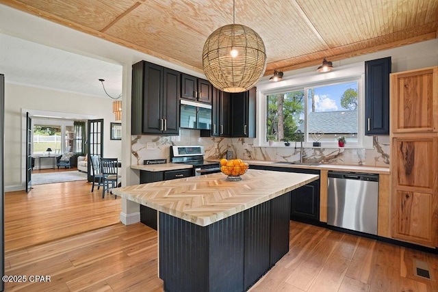 kitchen with light wood-type flooring, a sink, stainless steel appliances, and wooden ceiling