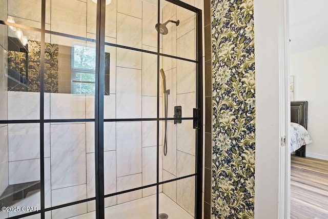 ensuite bathroom with a stall shower, wood finished floors, and ensuite bath