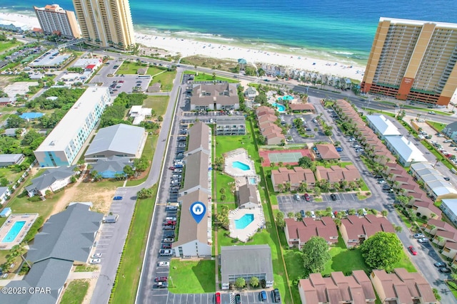 bird's eye view featuring a water view and a view of the beach