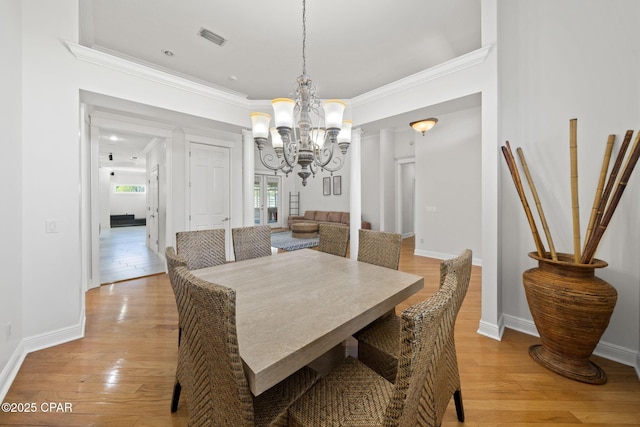 2015 Tupelo Ct, Panama City, FL 32405 - dining area with ornamental molding, visible vents, a notable chandelier, and light wood-style floors