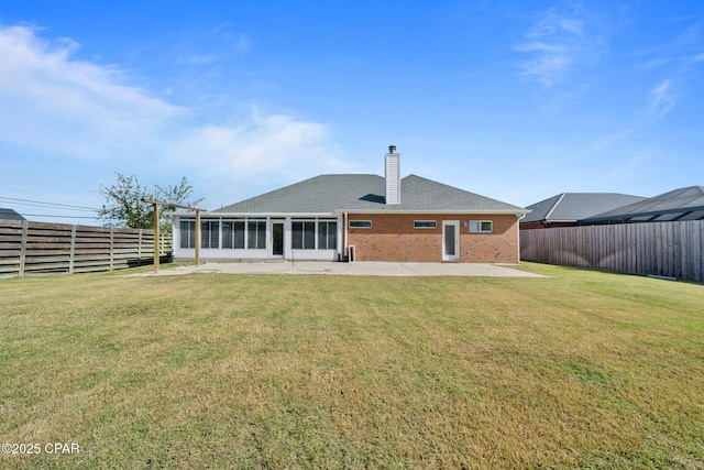 2015 Tupelo Ct, Panama City, FL 32405 - back of property featuring a fenced backyard, a chimney, and a lawn