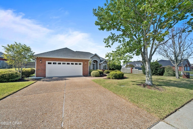 2015 Tupelo Ct, Panama City, FL 32405 - view of front facade with an attached garage, fence, brick siding, a front lawn, and driveway