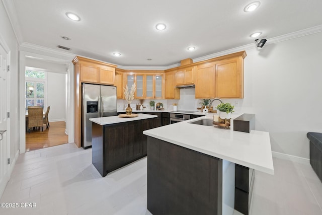 2015 Tupelo Ct, Panama City, FL 32405 - kitchen with stainless steel fridge, light countertops, crown molding, a kitchen island, and a sink