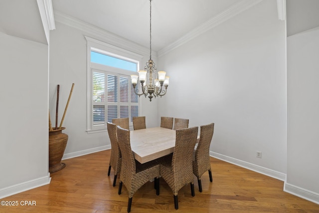 2015 Tupelo Ct, Panama City, FL 32405 - dining room featuring ornamental molding, baseboards, a notable chandelier, and wood finished floors