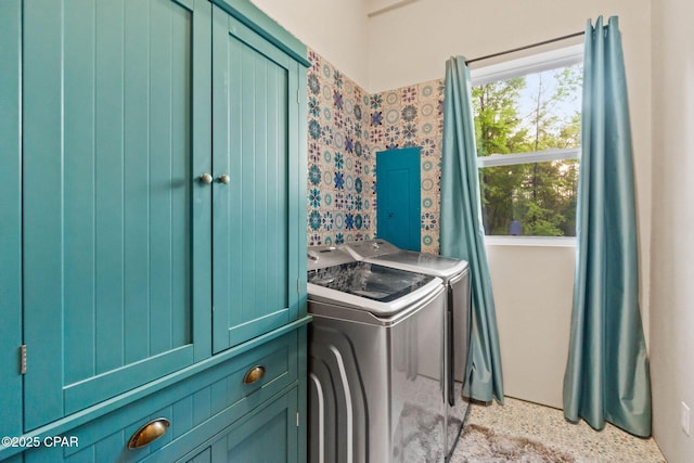 clothes washing area with cabinet space and washer and dryer