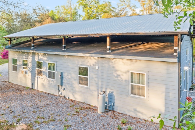 back of house featuring metal roof