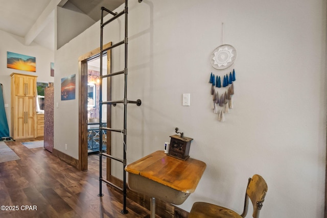 interior space with baseboards and dark wood-type flooring