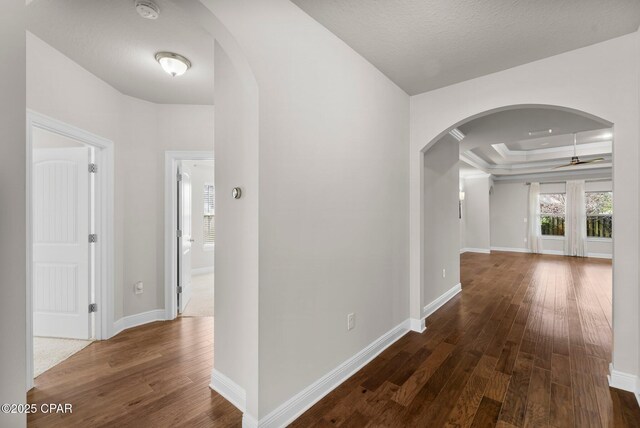 31 Viper Rd, Santa Rosa Beach, FL 32459 - corridor with arched walkways, hardwood / wood-style flooring, baseboards, and a raised ceiling