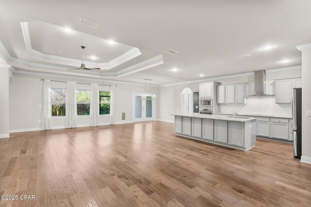 31 Viper Rd, Santa Rosa Beach, FL 32459 - kitchen with wall chimney range hood, open floor plan, appliances with stainless steel finishes, and an island with sink