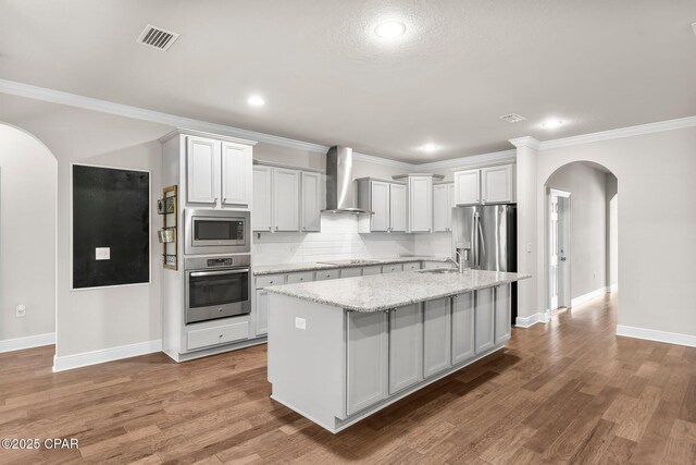 31 Viper Rd, Santa Rosa Beach, FL 32459 - kitchen featuring wall chimney exhaust hood, arched walkways, a sink, stainless steel appliances, and baseboards
