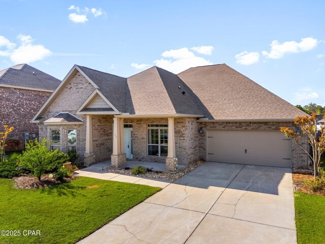 31 Viper Rd, Santa Rosa Beach, FL 32459 - view of front of property with a garage, a front lawn, brick siding, a shingled roof, and concrete driveway