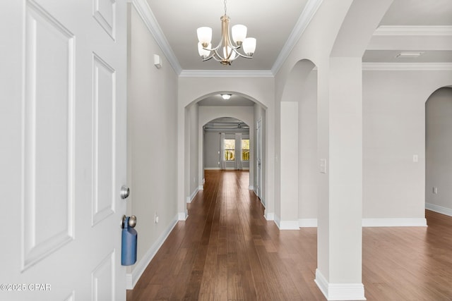 31 Viper Rd, Santa Rosa Beach, FL 32459 - foyer with an inviting chandelier, arched walkways, ornamental molding, dark wood-style flooring, and baseboards