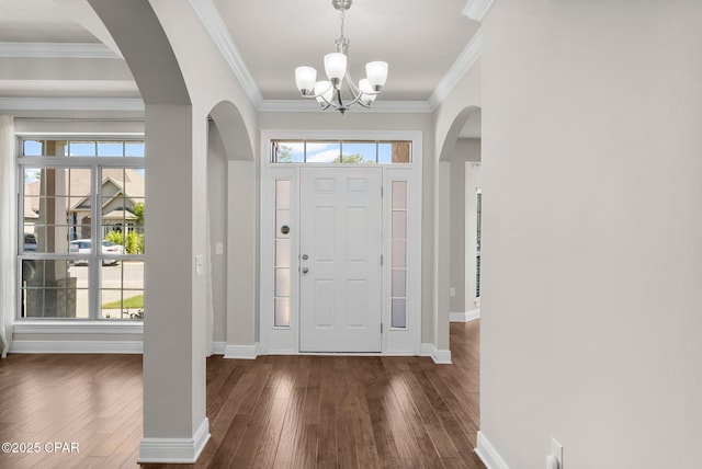 31 Viper Rd, Santa Rosa Beach, FL 32459 - foyer featuring baseboards, ornamental molding, a chandelier, dark wood finished floors, and arched walkways