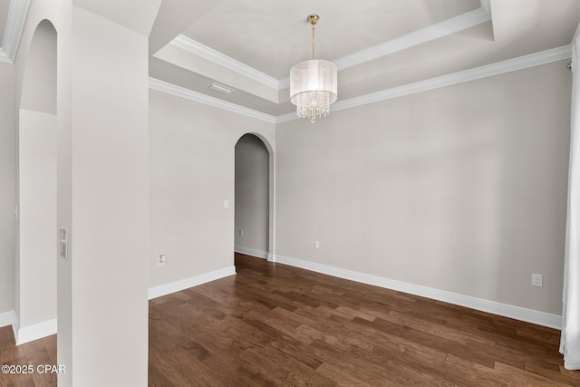 31 Viper Rd, Santa Rosa Beach, FL 32459 - empty room with visible vents, arched walkways, an inviting chandelier, dark wood-style flooring, and a tray ceiling