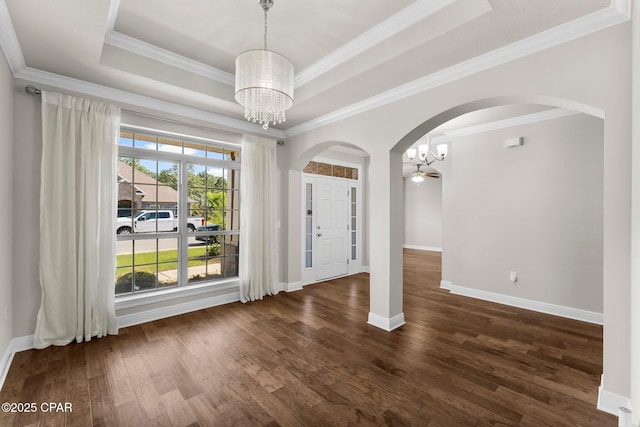 31 Viper Rd, Santa Rosa Beach, FL 32459 - unfurnished dining area featuring crown molding, arched walkways, a chandelier, dark wood-style flooring, and baseboards
